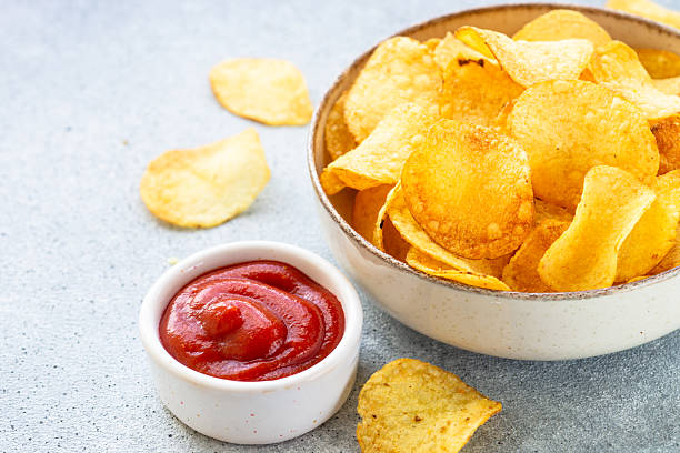 istock Potato chips in the bowl and ketchup sauce. 2216242830