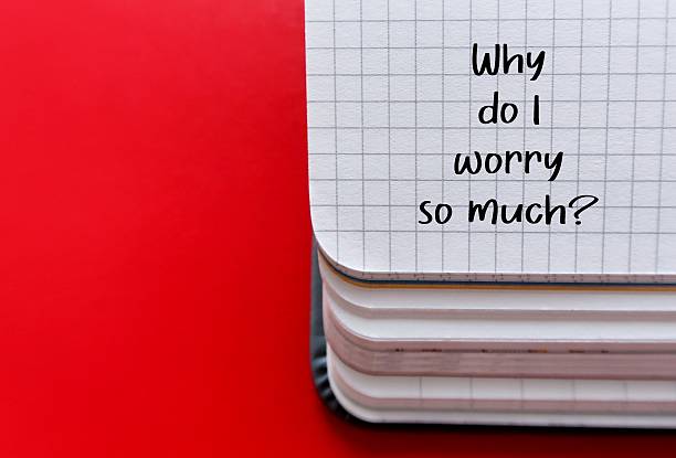 istock Notebook on red background wuth texte written - Why do I worry so much? - Question to ask when worries, doubts and anxieties becomes excessive, persistent and uncontrollable. Can't get anxious thoughts out of one head and interferes with daily life. 2216243926