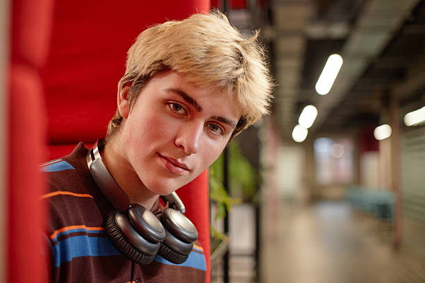 istock Teenage Boy Looking at Camera in Booth 2216249076