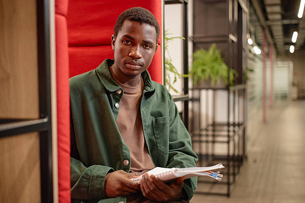 istock Young Black Man as Student Sitting in Lounge Booth 2216250498