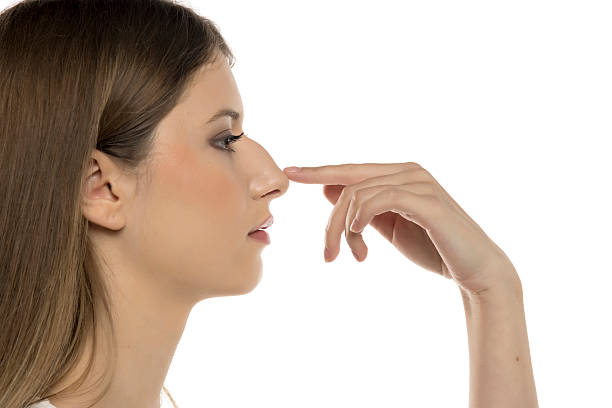 istock Profile View of a Woman Touching Her Hampback Nose Elegantly. 2216251225