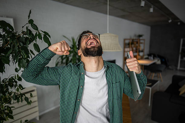 istock Excited freelancer celebrating success working from home 2216251768
