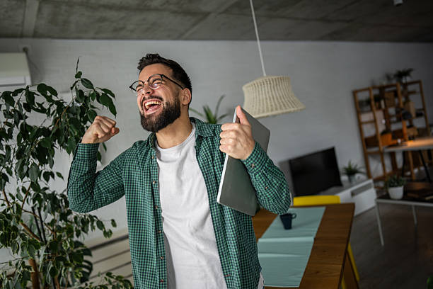 Excited freelancer celebrating success working from home