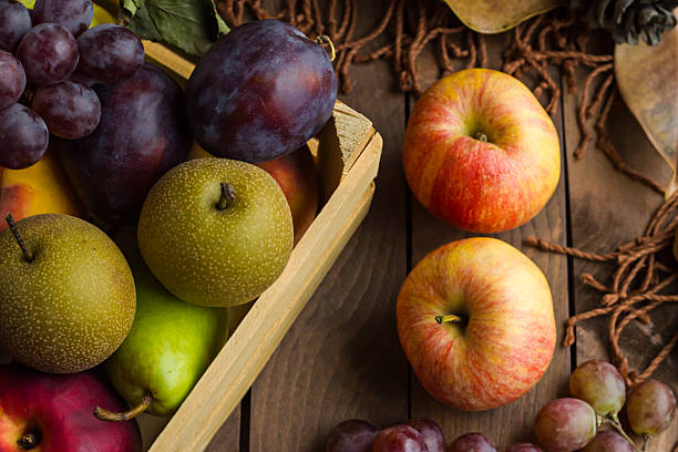 Conceptual image of harvesting with ripe and fresh fruits on wooden table