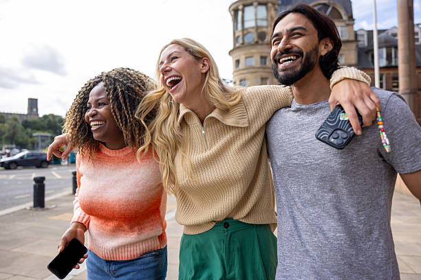 istock Cheerful City Walks with Friends 2216253530