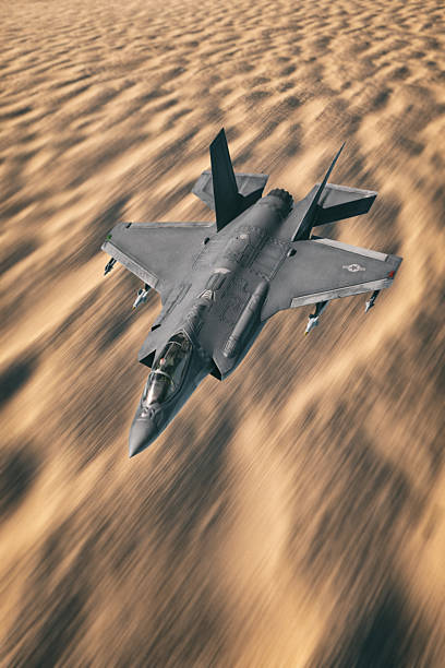 State of the art F-35 A stealth strike fighters in flight above a desert location. Scale model photography.