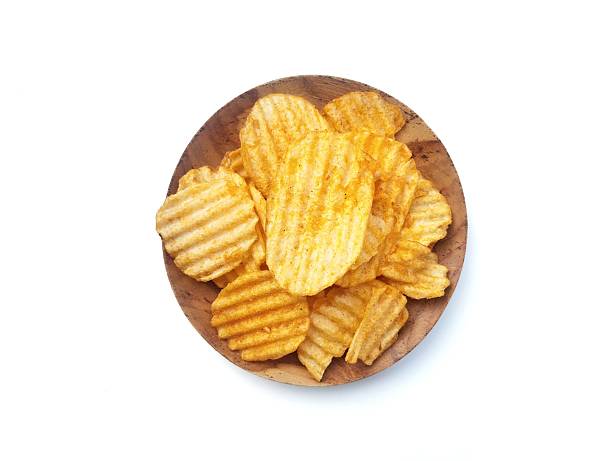 istock Potato chips on plate isolated on white background 2216254937
