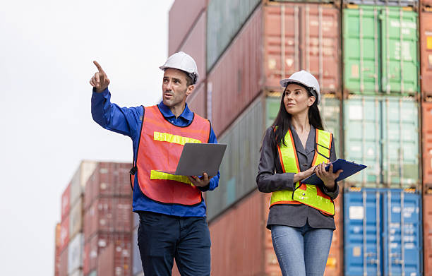istock Engineer and Foreman Team Working at Industry Containers Cargo, Logistics Professional Inspecting Containers Box at Shipping Yard 2216257077