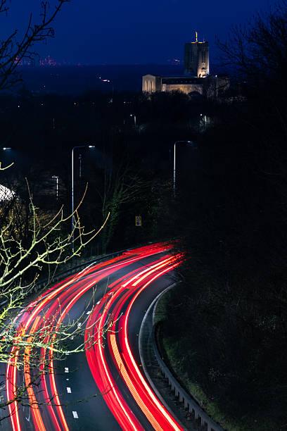 Wide angle view of cars traveling on a motorway at dusk.