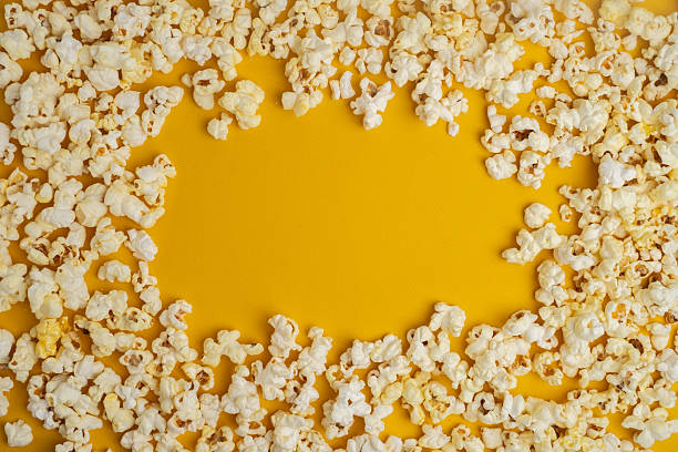 Sweet popcorn.Flying Sweet popcorn on a light brown background
