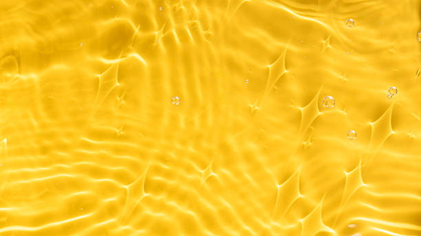 istock Abstract background of yellow water with ripples under sunlight. Top view, copy space. 2216262191