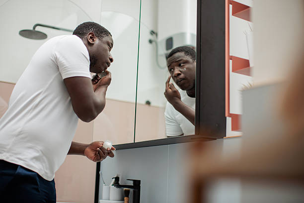 istock Man Applying Facial Cream 2216262942