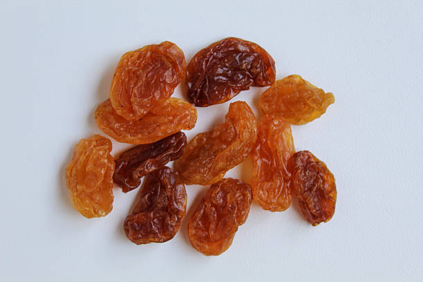 Scattered raisins on isolated white background