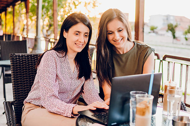 istock Two business woman using laptop in cafe 2216267405