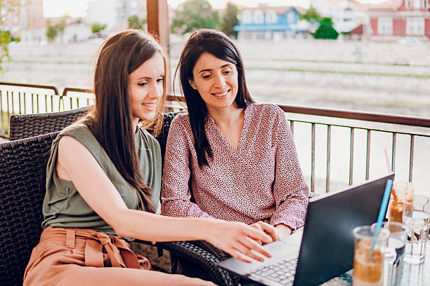 istock Two business woman using laptop in cafe 2216267464