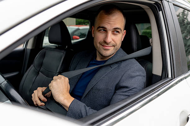 istock Businessman fastening seat belt while sitting in car 2216267591