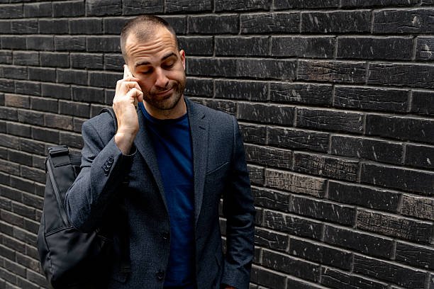 istock Businessman talking on the phone with a skeptical expression 2216267643