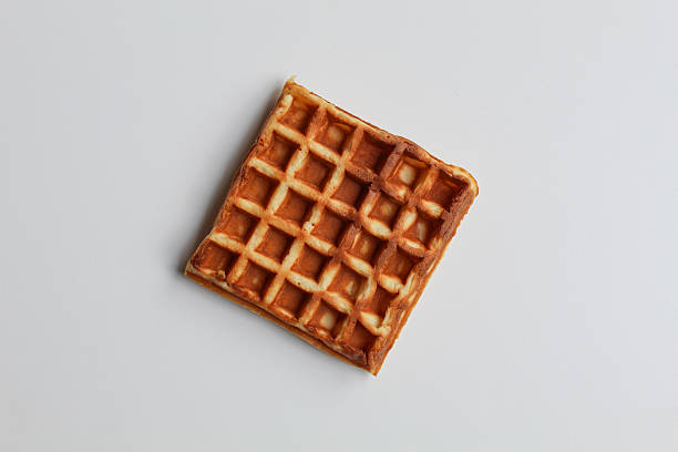 Close up texture of plain waffle, burnt side, square patterned, flat lay or top view