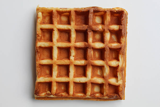 Close up texture of plain waffle, burnt side, square patterned, flat lay or top view