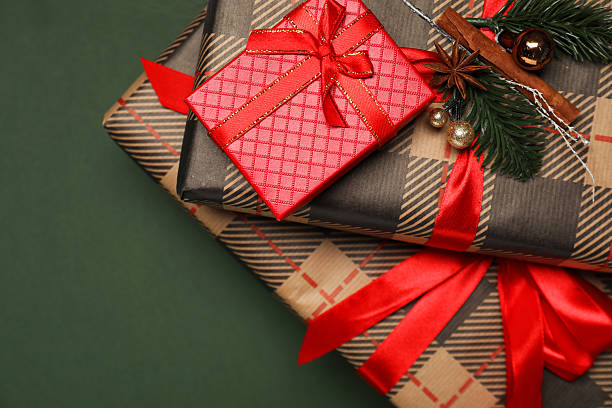 istock Christmas gift boxes on dark green background, top view. Space for text 2216270216