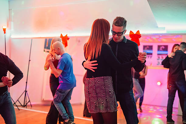 istock Man And A Woman Dancing Salsa At The Studio Dance Party 2216270580