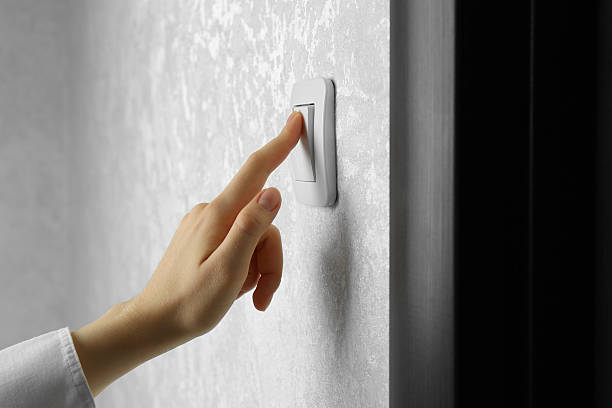 istock Woman turning light switch on, closeup view 2216270790