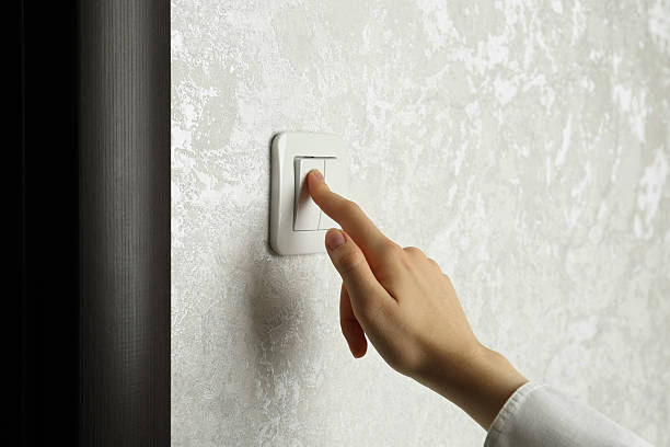 istock Woman turning light switch on, closeup view 2216270797