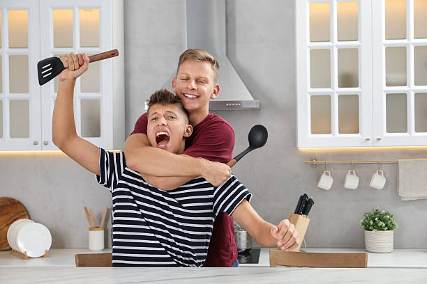 istock Two happy brothers having fun in kitchen 2216271369