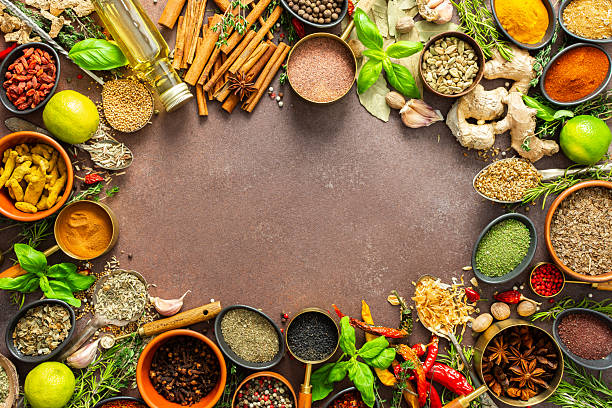 istock A diverse collection of vibrant spices and herbs, elegantly positioned on a brown backdrop, exuding natural beauty and a burst of fragrances, spice frame 2216272998