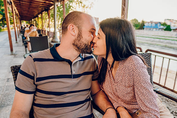 Happy couple sitting in cafe. They enjoying in their love.