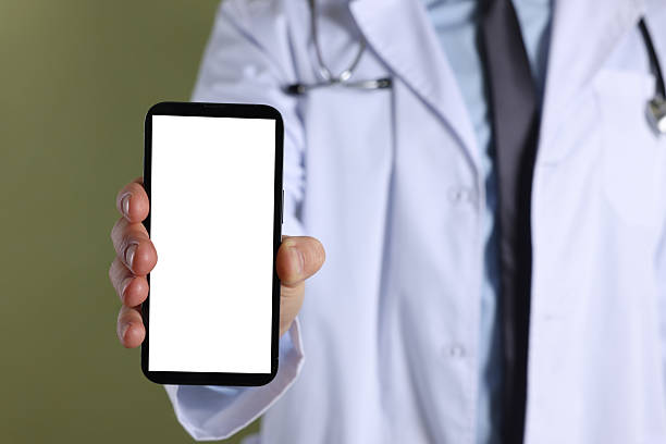 istock Doctor showing smartphone with blank screen on olive background, closeup. Mockup for design 2216276303