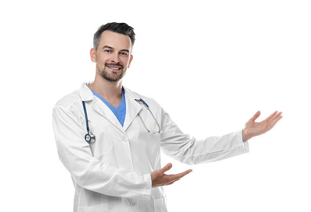 istock Smiling doctor with stethoscope pointing at something on white background 2216276377