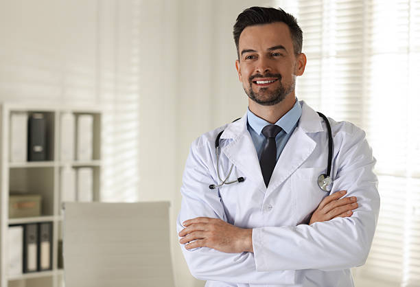 istock Smiling doctor with stethoscope in clinic, space for text 2216276428