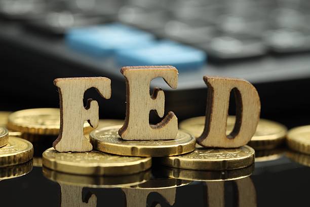 istock Word Fed (Federal Reserve System) made with letters and coins on dark mirror table 2216278018