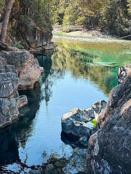 istock Clear green-blue river flowing through forested valley 2216280010
