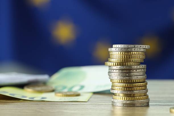 istock Coins and euro banknotes on wooden table, closeup 2216280876
