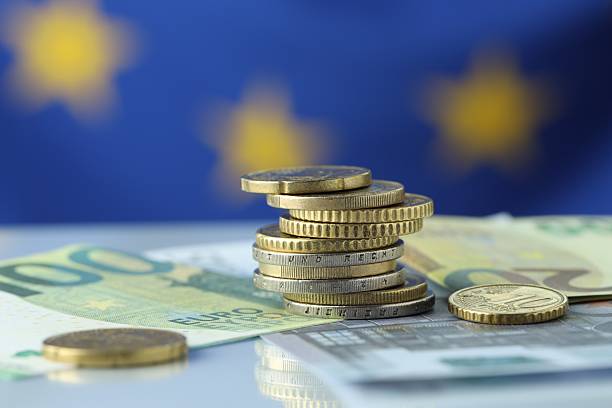 istock Coins and euro banknotes on table, closeup 2216280933