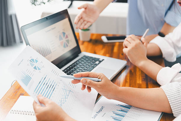 istock Teamwork meeting, business people in office workplace. Collaboration, technology and worker, employees with touchscreen planning sales, research or financial strategy, staff for conversation, graph 2216281466