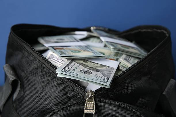 istock Dollar banknotes in bag on blue background, closeup 2216281569
