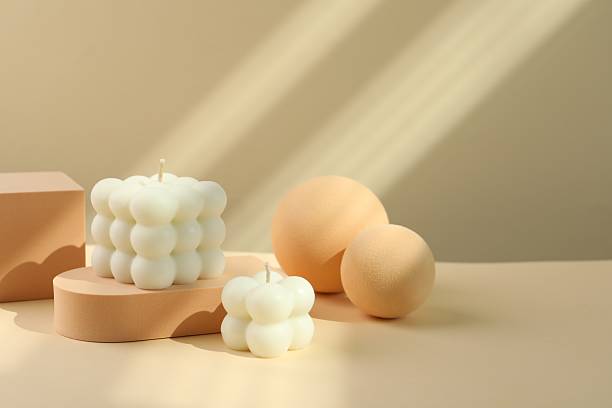 istock Beautiful bubble candles and geometric figures on beige background 2216281869
