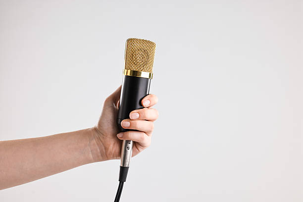 istock Woman with microphone on grey background, closeup. Space for text 2216282752