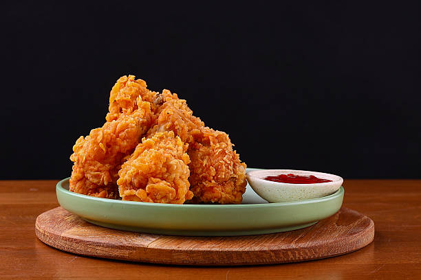 istock Crispy Fried Chicken Drumsticks with Sweet Chili Dip on Green Plate 2216282766