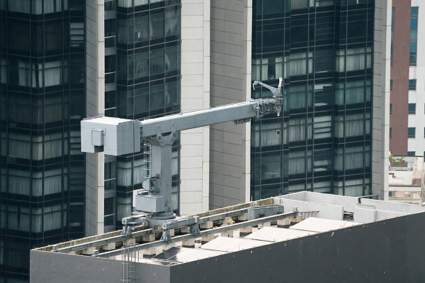 Building Maintenance Unit (BMU). Building site with cranes. Safety concept.
