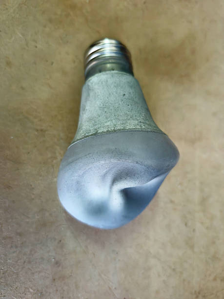 White LED lighting bulb on the work bench, damaged by the heat.
