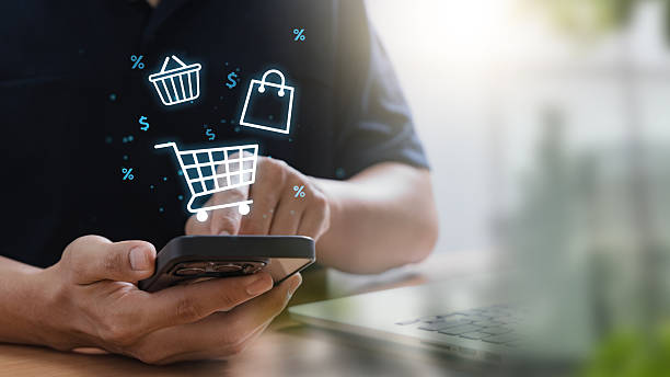 istock E-commerce and online shopping concept with man using smartphone to browse products and make digital purchases, illustrating mobile commerce, and the shift toward digital retail experiences 2216284064