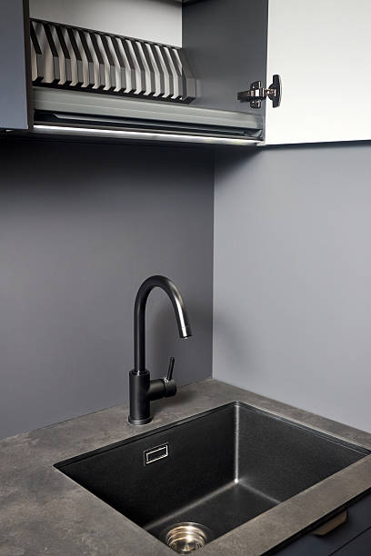 istock Single handle water filter kitchen faucet reverse osmosis or water filtration. Compact high pressure laminate HPL countertop undermount installation granite composite sink, opened dish drying cabinet. 2216286055