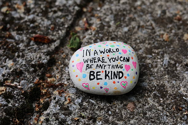 istock In a world where you can be anything be kind rock on old stone surface 2216287222