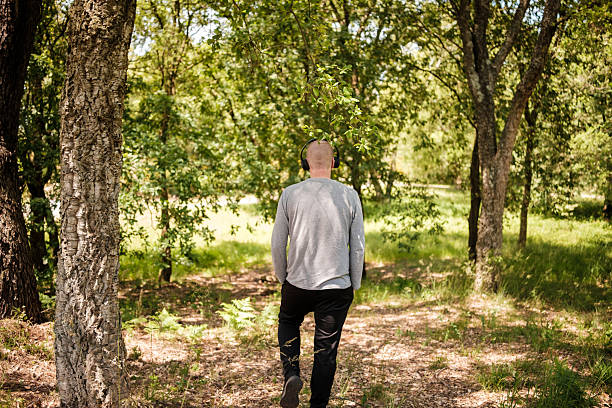 istock Man enjoying music while walking in a peaceful forest 2216290259