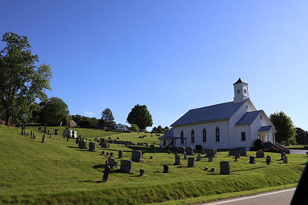 Beautiful white historic church on a hill next to a graveyard