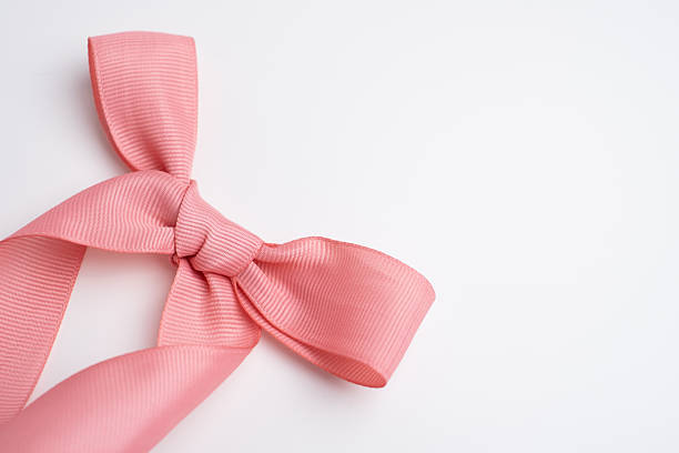 Pink bow on white background. Top view. Holiday card